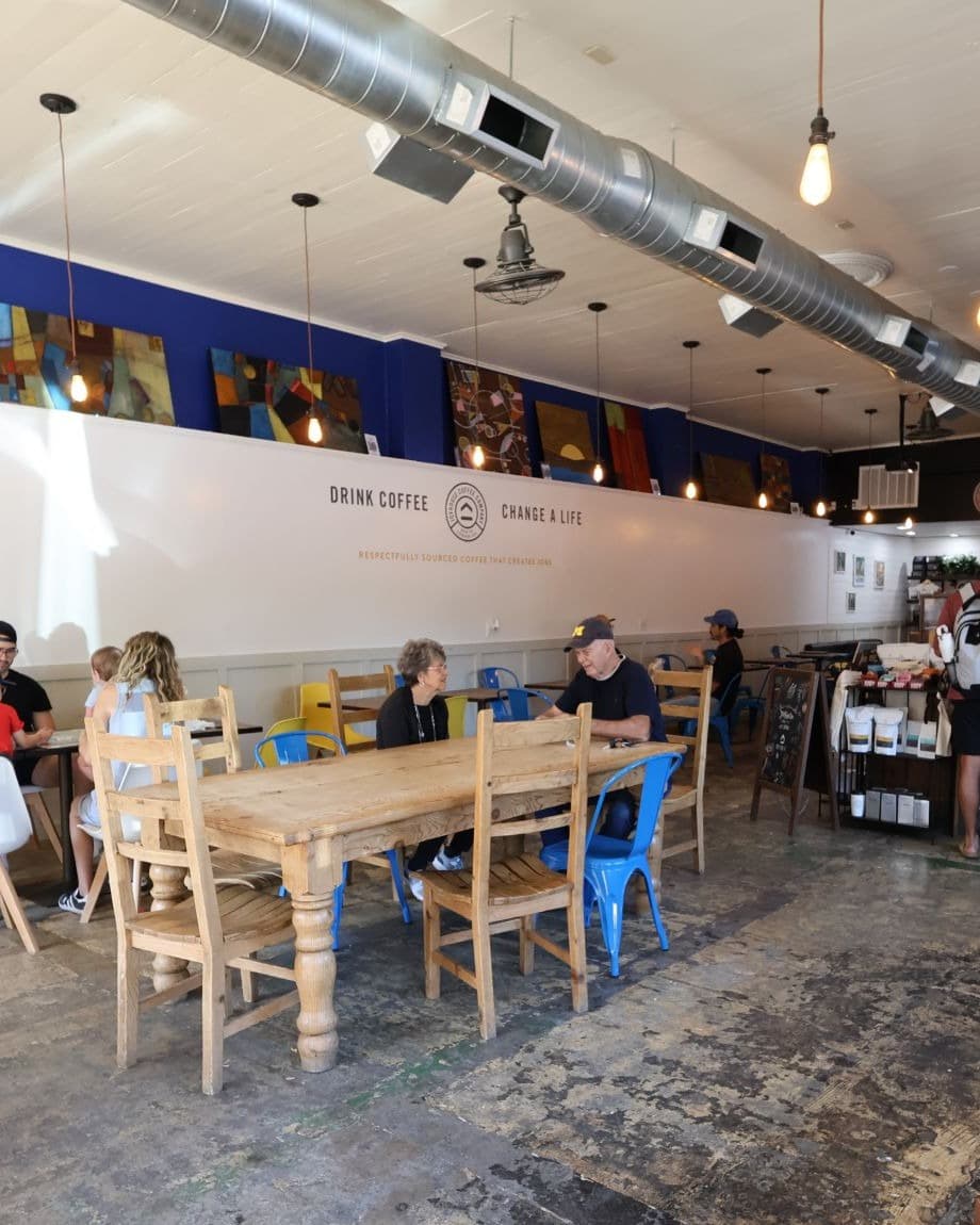 The Joyhouse cafe room in Cave Springs, customers at the long communal table