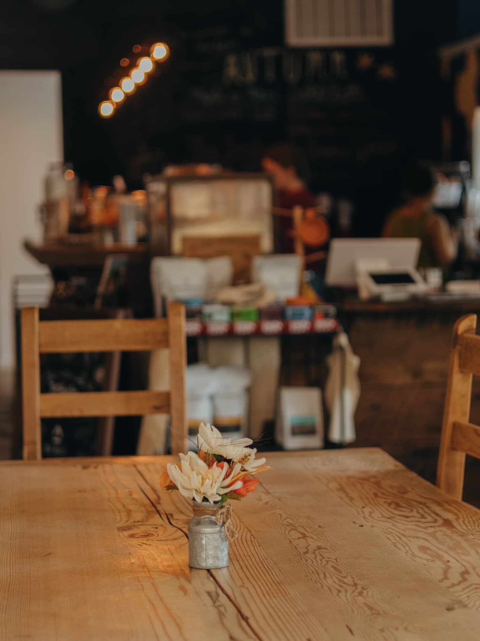 A table in the Joyhouse cafe, the counter and its shelf of coffee bags behind